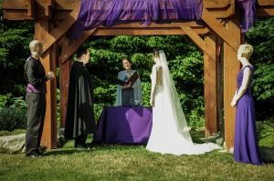wedding party under ceremony arch.