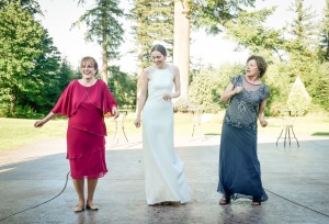 Casey dancing with her mother and mother-in-law on either side.
