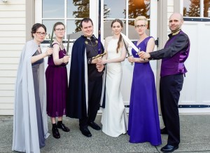 wedding party all wielding daggers and swords.