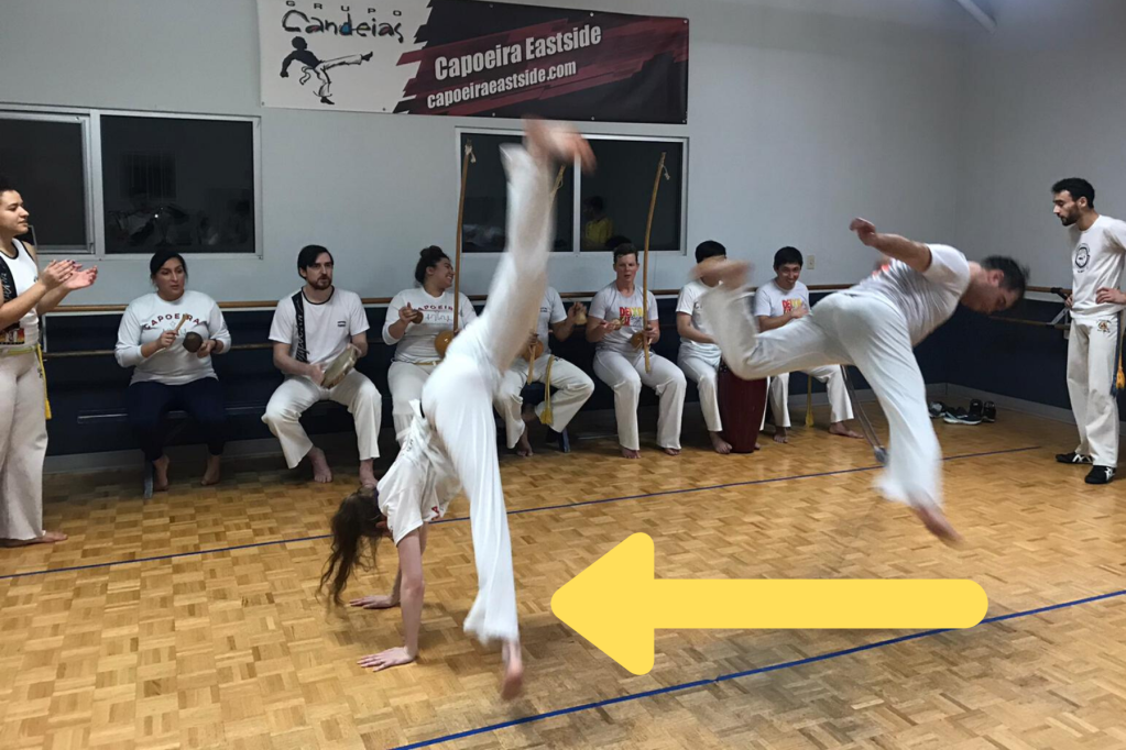 Casey cartwheeling in a capoeira roda.